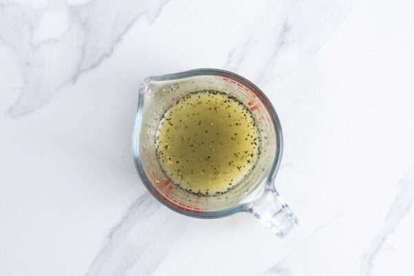 fresh lime juice and black pepper in a glass measuring cup.
