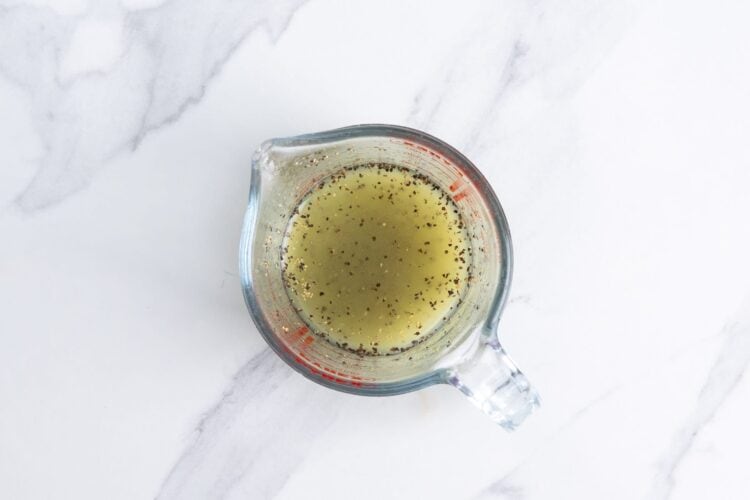 fresh lime juice and black pepper in a glass measuring cup.