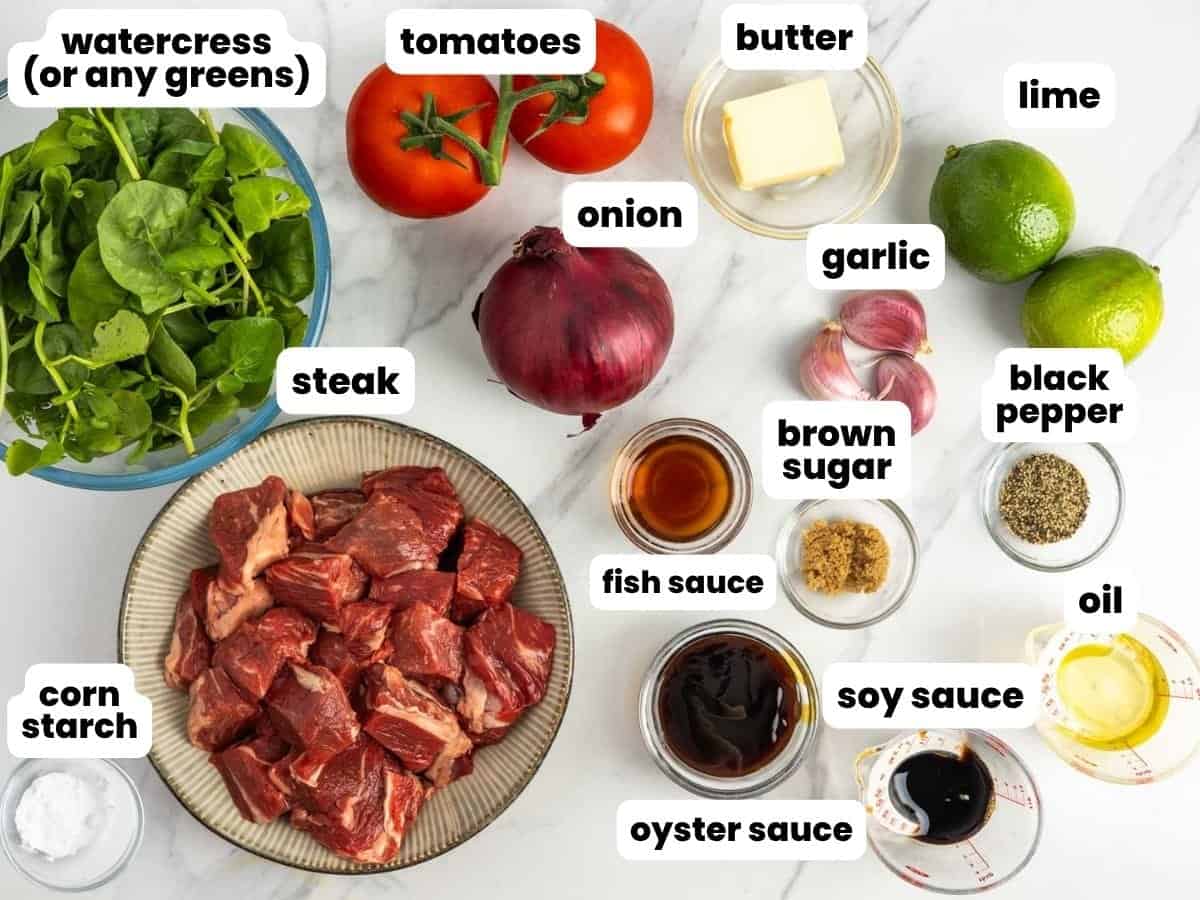 Ingredients for Vietnamese shaking beef, including steak, onions, and watercress.