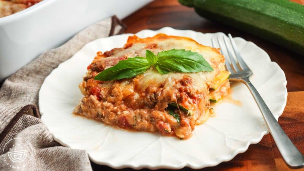 a slice of zucchini lasagna on a plate with ricotta and meat layers holding shape.