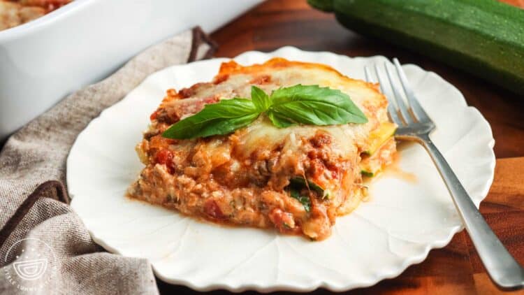 a slice of zucchini lasagna on a plate with ricotta and meat layers holding shape.