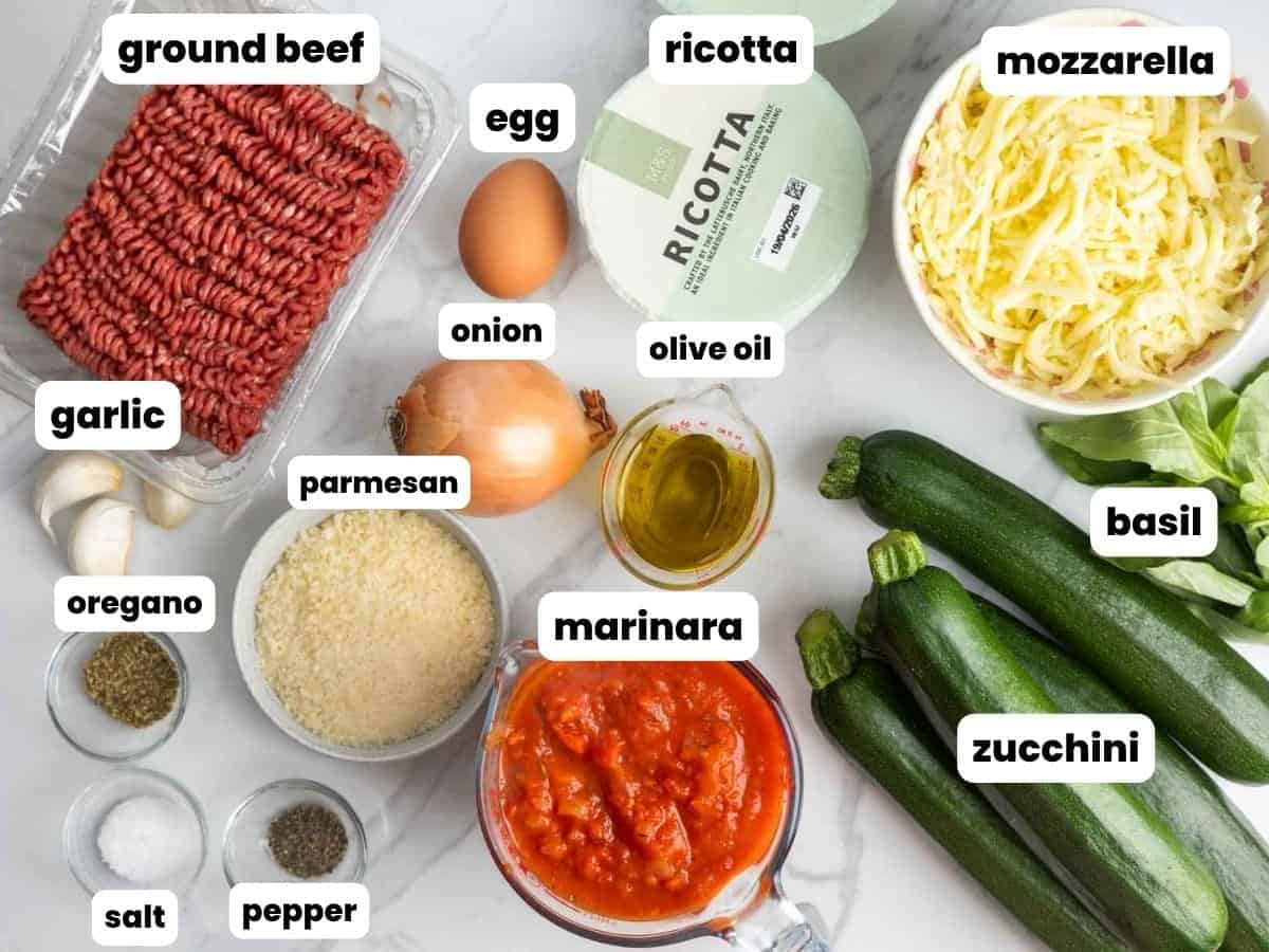 Ingredients for zucchini lasagna with ricotta and ground beef, arranged on a counter.