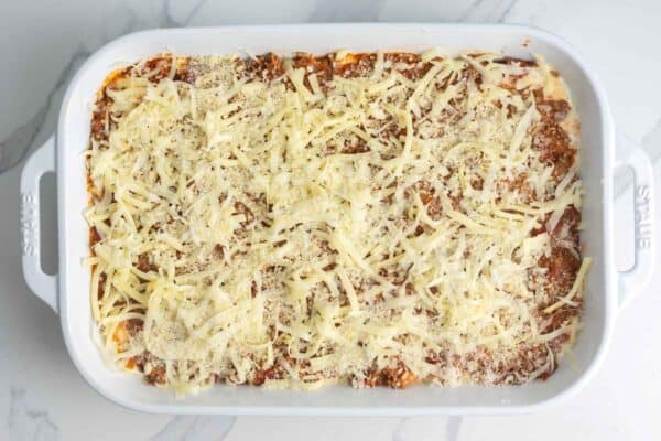 The top layer of zucchini lasagna with ground beef tomato sauce and shredded cheese.