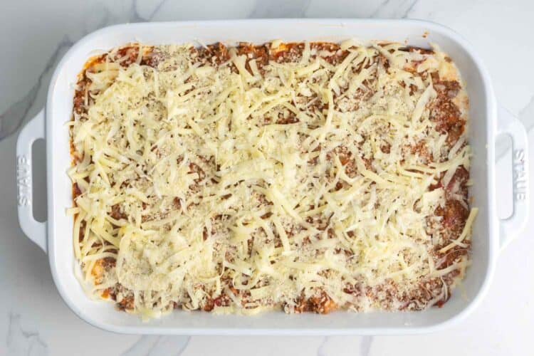 The top layer of zucchini lasagna with ground beef tomato sauce and shredded cheese.