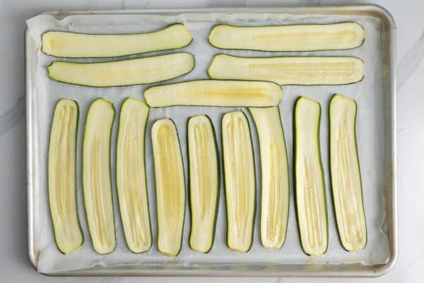 lightly roasted and slightly dried slices of zucchini on a baking sheet.