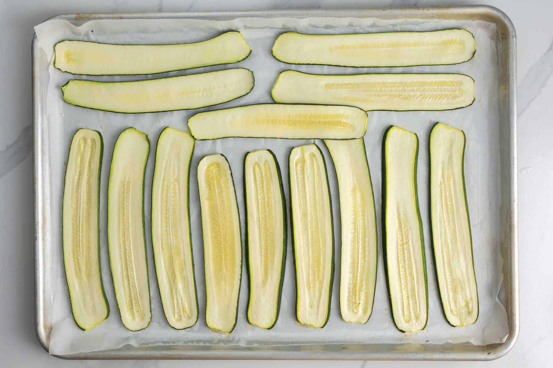 lightly roasted and slightly dried slices of zucchini on a baking sheet.