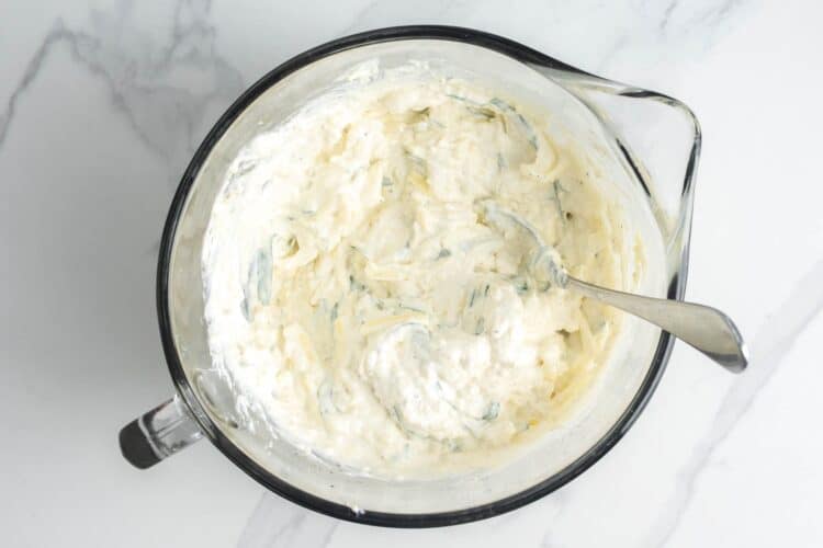 Ricotta mixed with egg, mozzarella, and herbs to create a creamy texture.