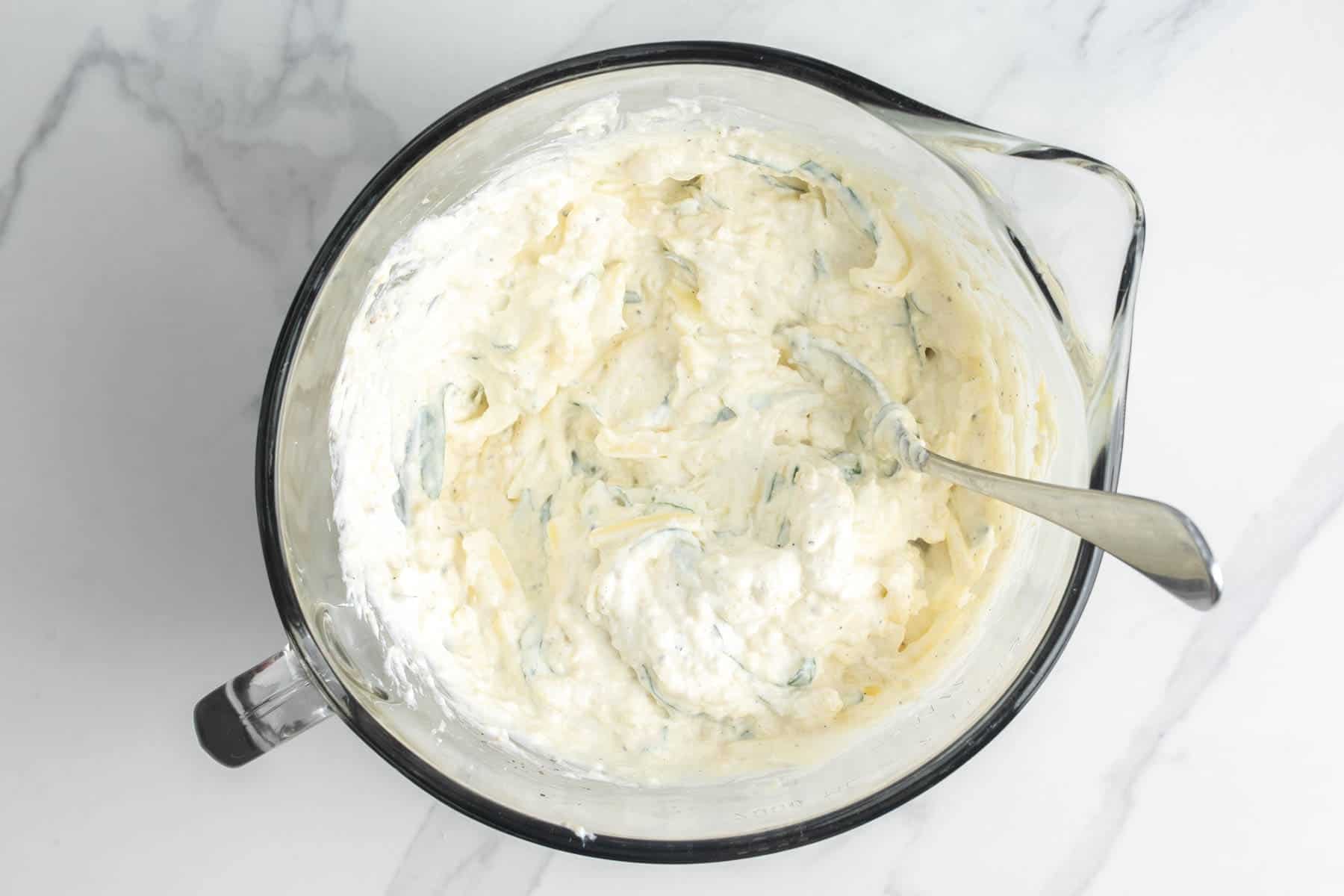 Ricotta mixed with egg, mozzarella, and herbs to create a creamy texture.