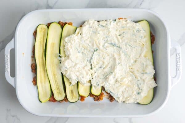 meatsauce, zucchini, and ricotta, layered to create lasagna in a 9x13 inch pan.