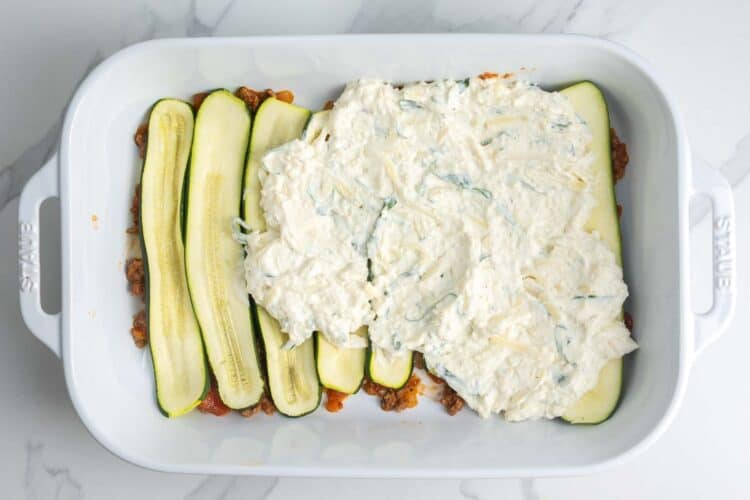 meatsauce, zucchini, and ricotta, layered to create lasagna in a 9x13 inch pan.