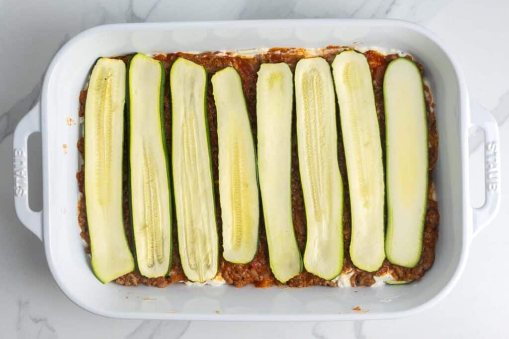 a second layer of roasted zucchini in a pan for zucchini lasagna.