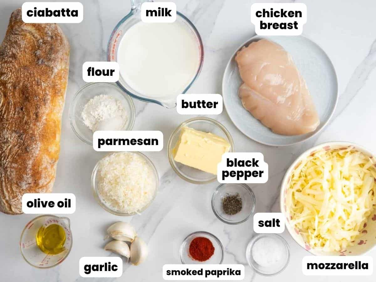 Ingredients for chicken Alfredo garlic bread including ciabatta, chicken breast, milk, mozzarella, parmesan, butter, garlic, olive oil, flour, salt, black pepper, and smoked paprika.