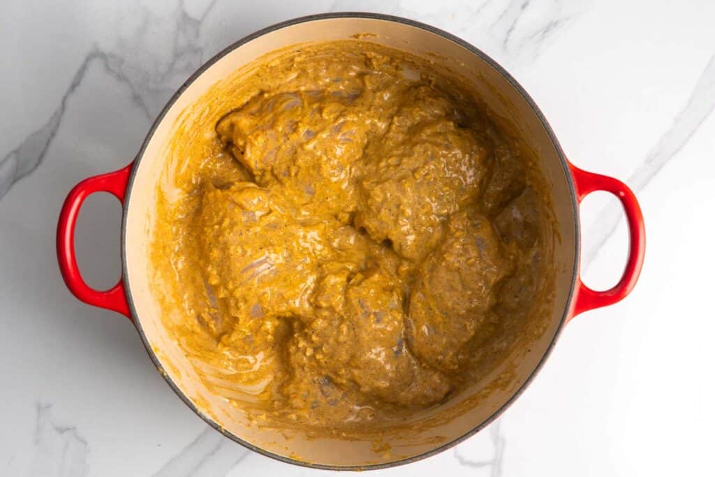 chicken thighs marinating in spiced yogurt.