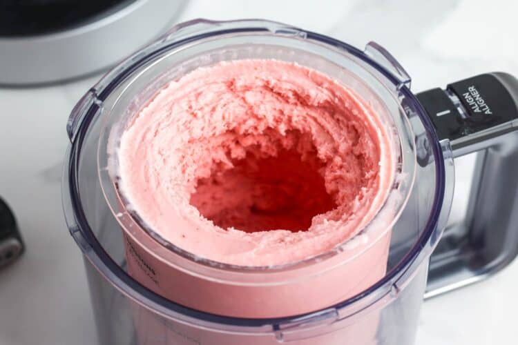 Processed strawberry ice cream in a Ninja Creami machine after spinning
