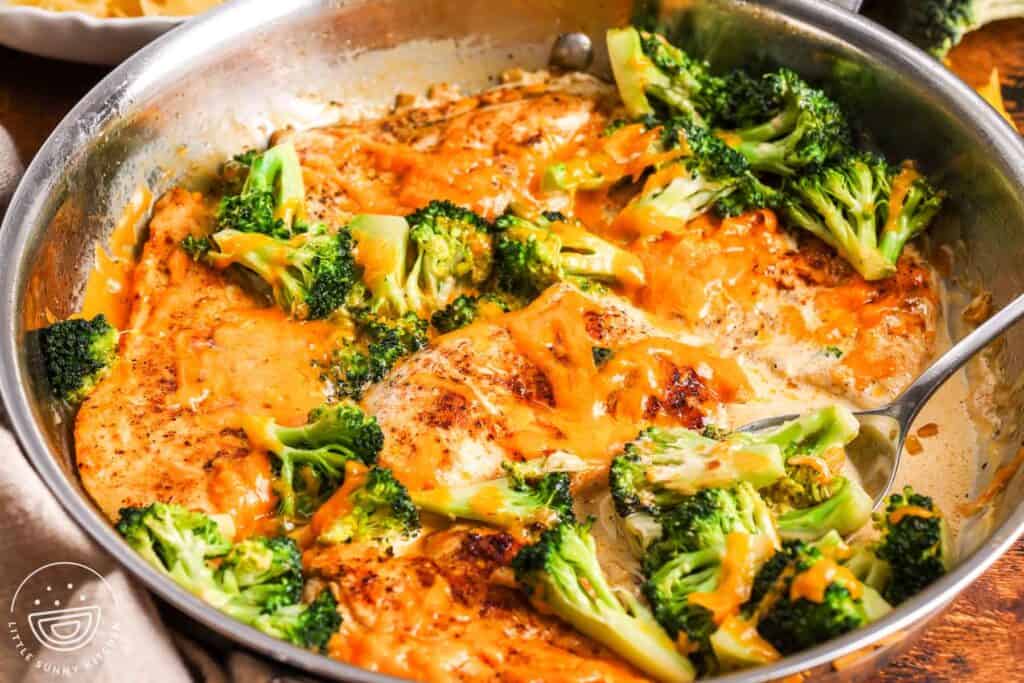 browned chicken, tender small broccoli florets,and cheese sauce in a skillet.