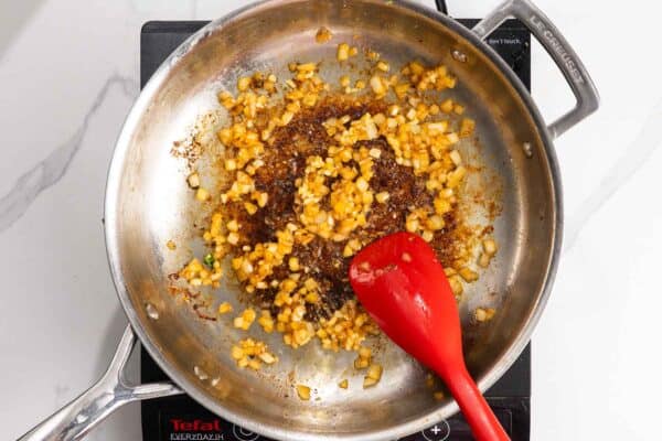 yellow onion sauteed in a pan.