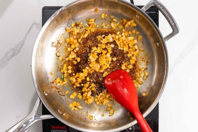 yellow onion sauteed in a pan.