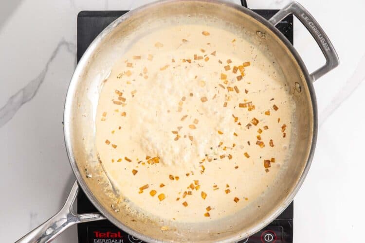 Heavy cream added to a skillet to create a pan sauce.