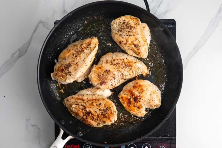 5 chicken breasts browned in a skillet