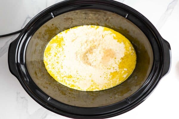 cream and parmesan added to a crockpot to make a sauce.