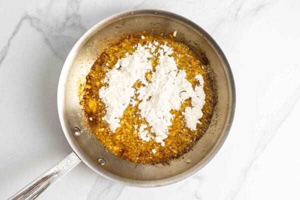 Garlic and butter cooking with flour in a skillet to start the Alfredo sauce.