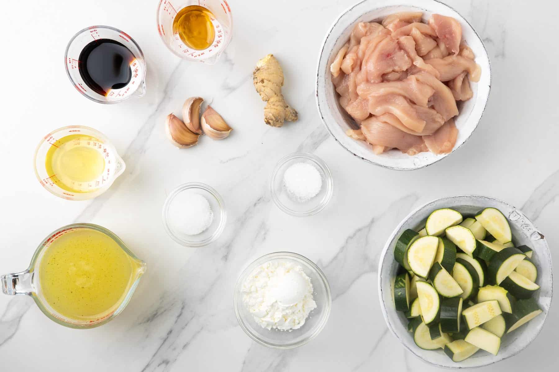 ingredients for making a chicken and zucchini stir fry with garlic and ginger.
