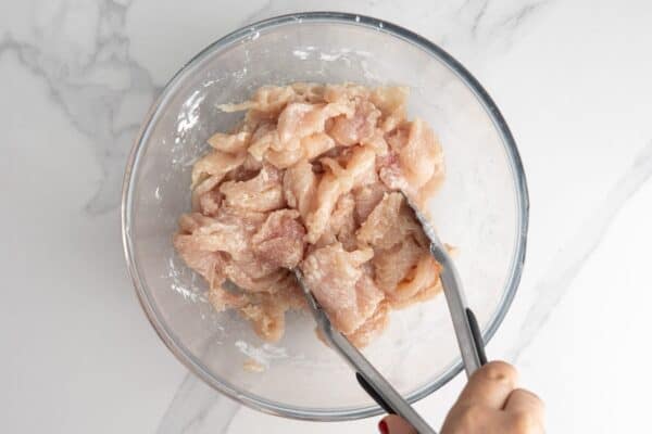 chicken velveted with cornstarch in a bowl.