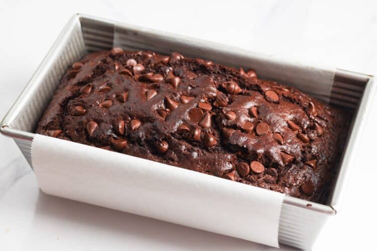 baked loaf of double chocolate zucchini bread in a loaf pan.