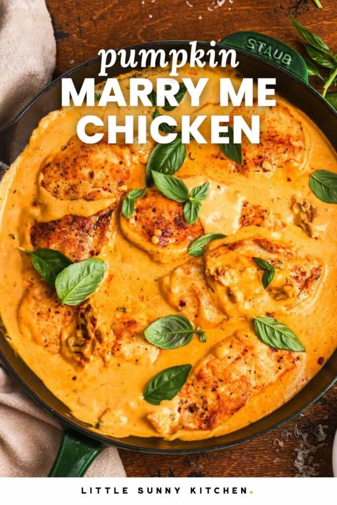 Overhead view of chicken cutlets simmered in creamy pumpkin Parmesan sauce and topped with fresh basil.