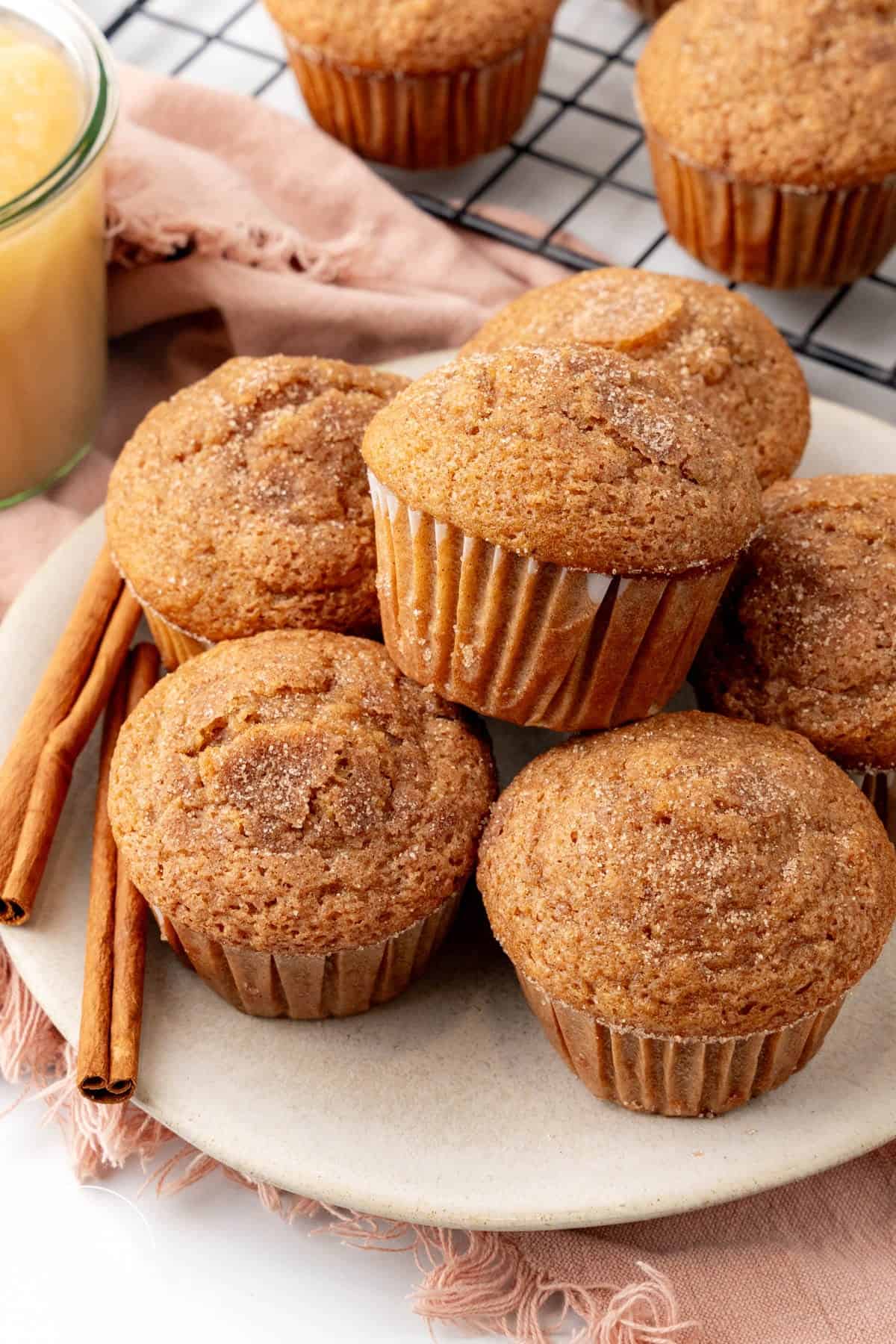 a plate of muffins made with applesauce, topped with cinnamon sugar.