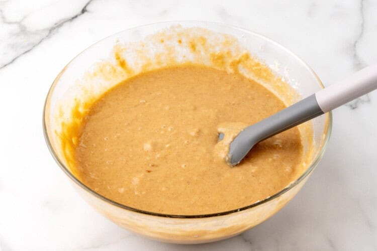 applesauce muffin batter in a glass mixing bowl.