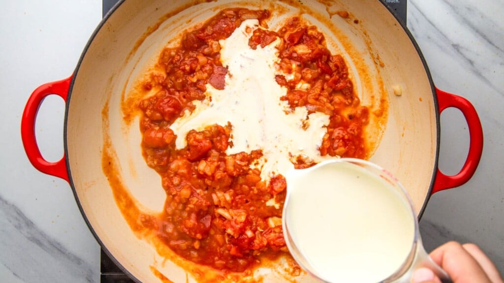 heavy cream added to apan with tomatoes and onions.