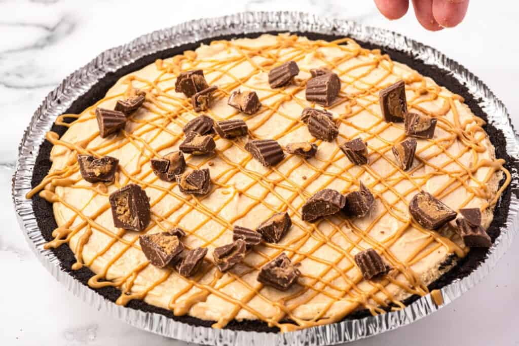 peanut butter pie topped with chopped mini peanut butter cups.