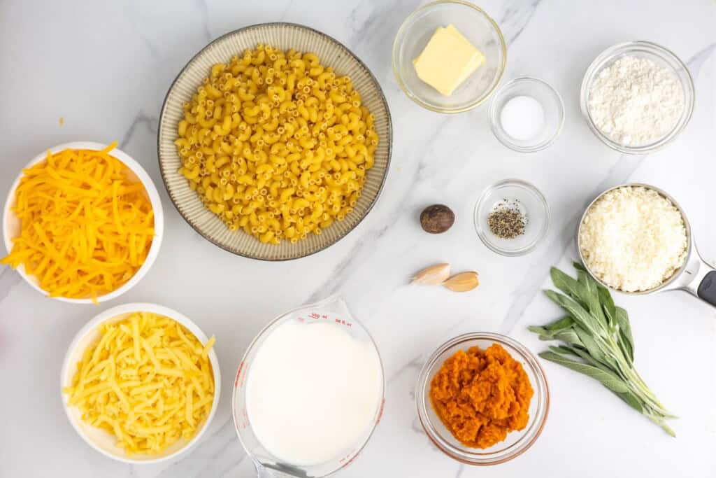 ingredients for pumpkin mac and cheese with cheddar and elbow noodles.