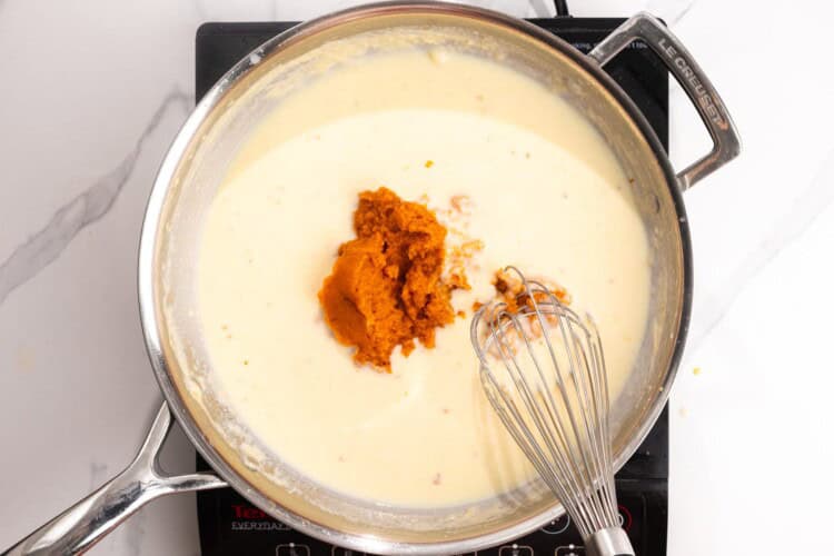 cream and pumpkin added to a roux to make a sauce for mac and cheese.