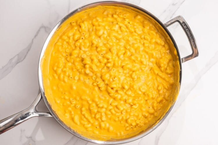 creamy stovetop pumpkin mac and cheese in a skillet.