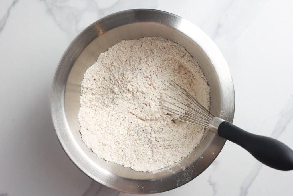 Flour in a metal mixing bowl, whisked.