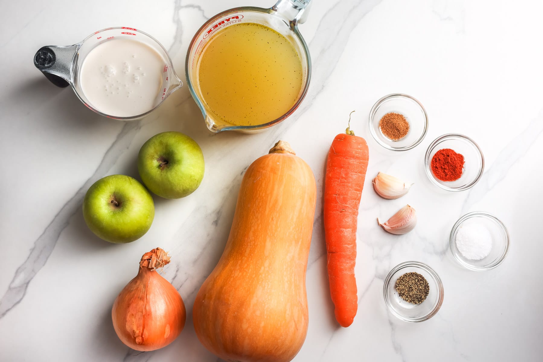 Butternut squash, Granny Smith apples, onion, carrot, garlic, vegetable stock, coconut milk, and seasonings for butternut squash apple soup