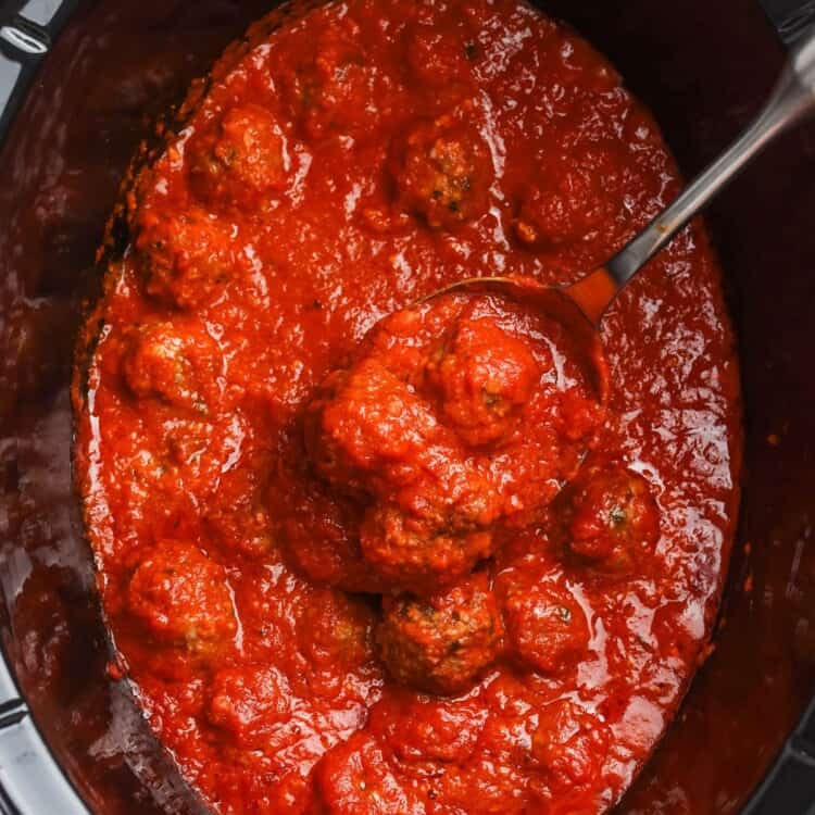 cooked meatballs in sauce in a crock pot, viewed from overhead.