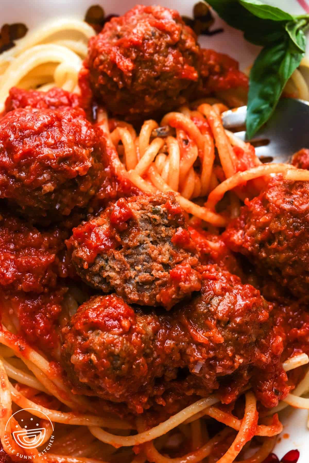 slow cooker meatballs with spaghetti, closeup.