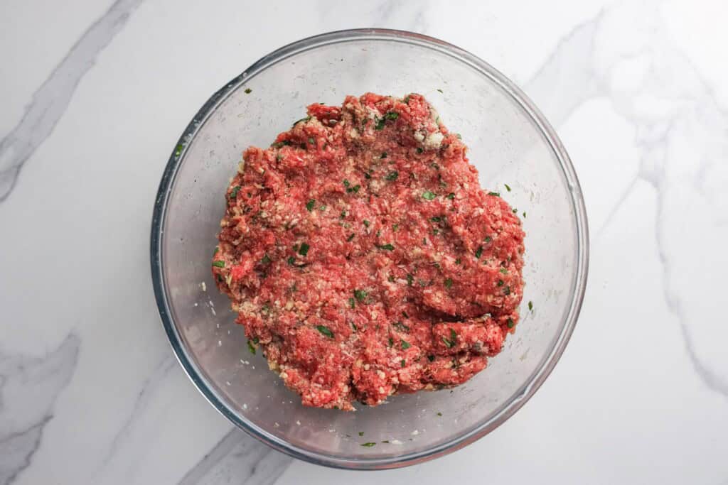 combined meatball mixture in a glass bowl.