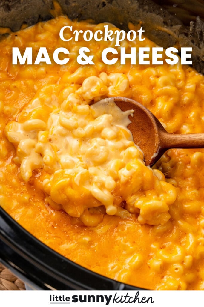 creamy macaroni and cheese in a slow cooker with a wooden spoon. Text overlay says "crockpot mac & cheese"