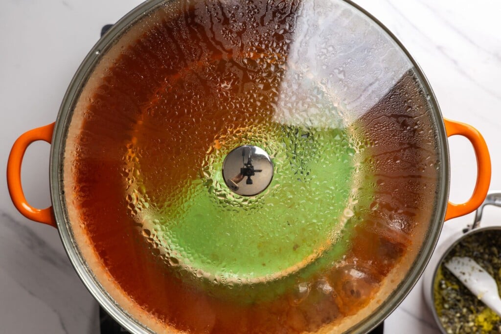 Kousa mahshi simmering in a covered Dutch oven.
