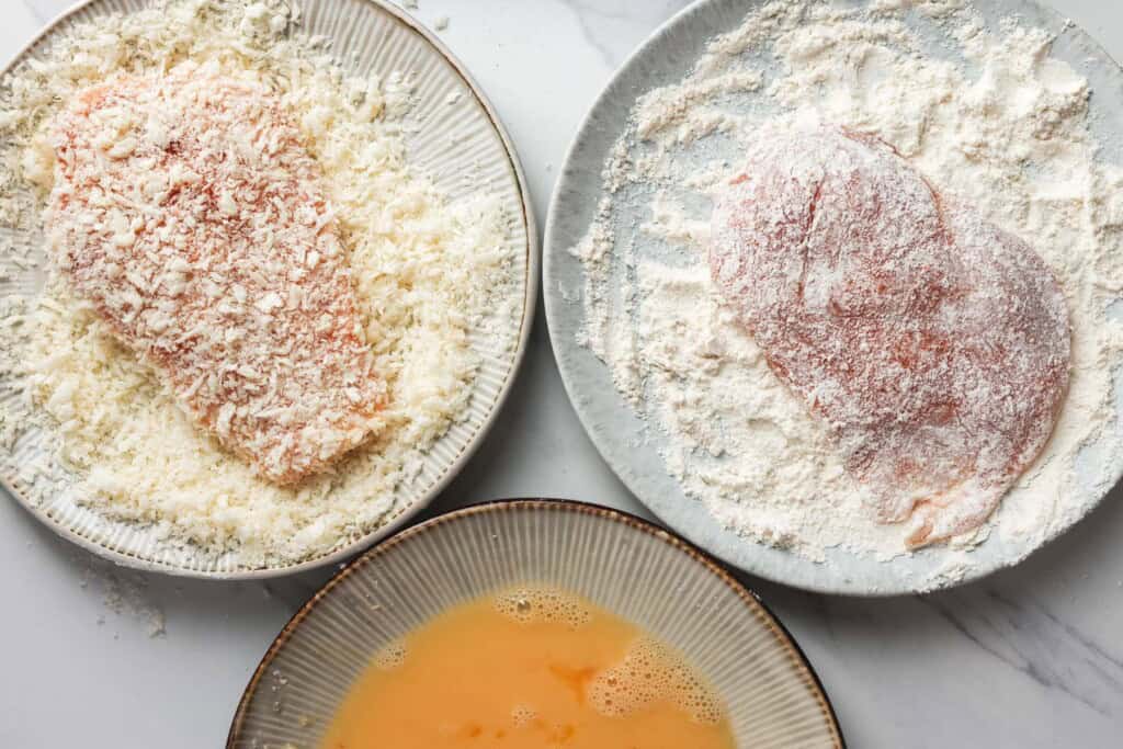chicken cutlets shown being breaded with flour, egg, and panko