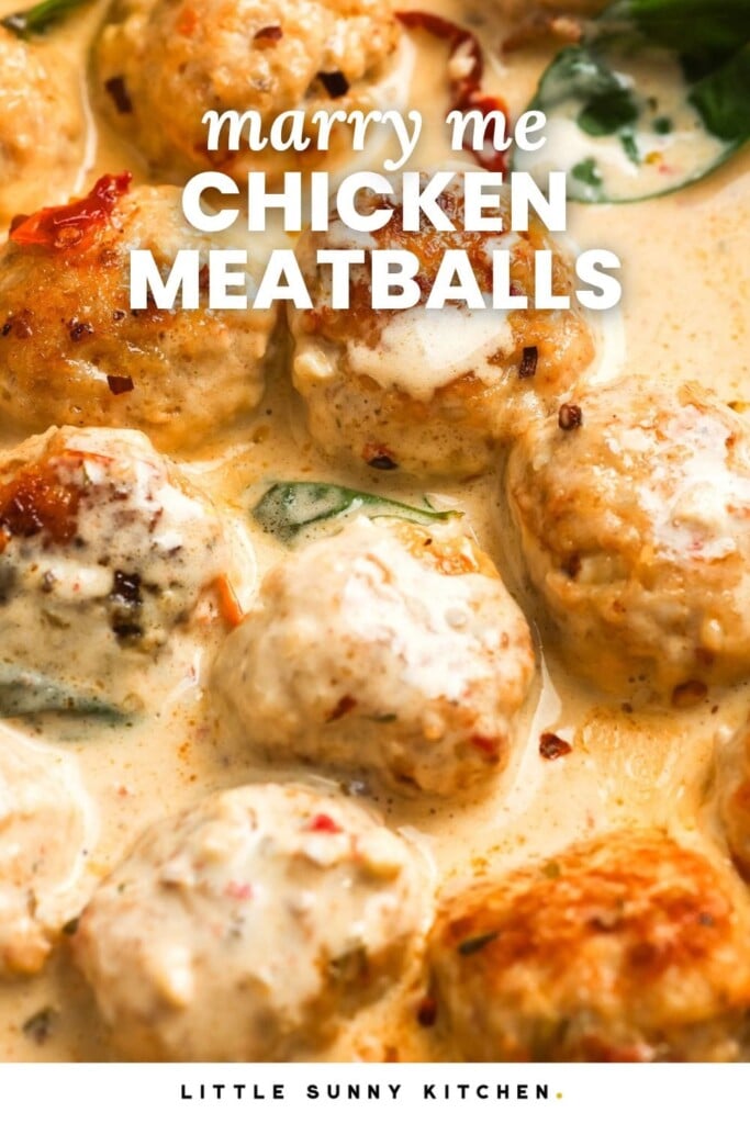 closeup of chicken meatballs in a creamy sauce with basil. Text overlay reads "marry me chicken meatballs"
