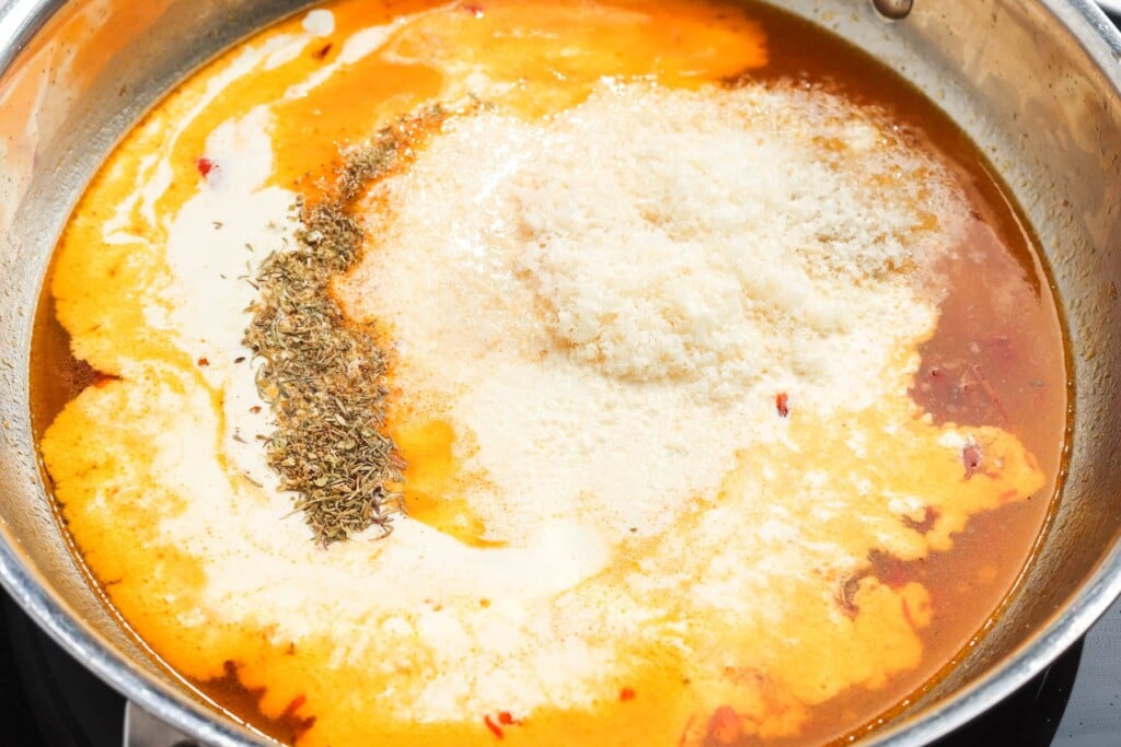 broth, cream, herbs, and parmesan in a skillet to make marry me chicken sauce.