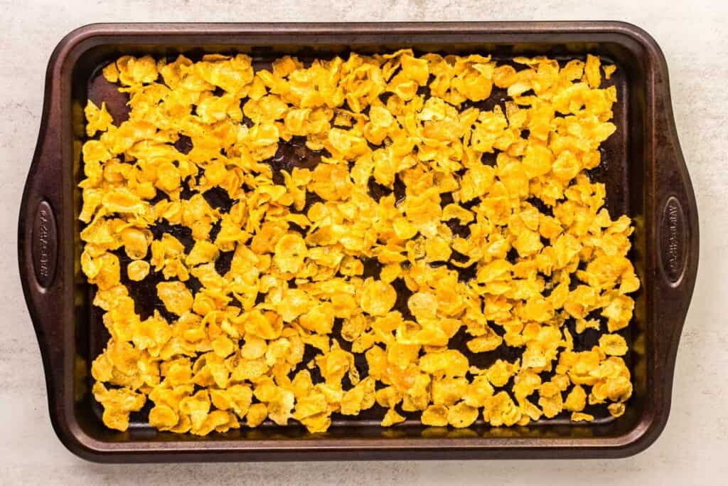 cornflakes spread on a baking sheet