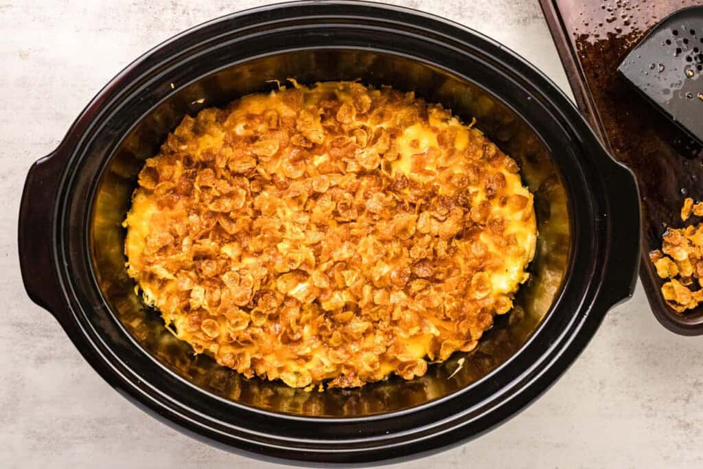 crockpot cheesy potatoes topped with crispy cornflakes