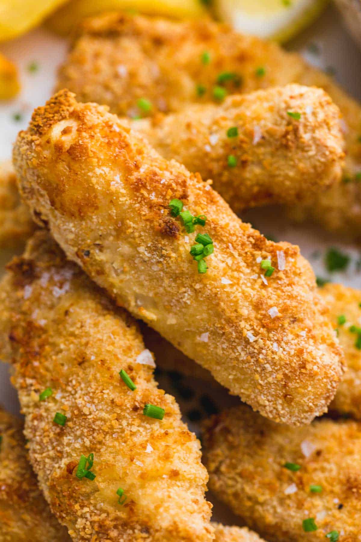 A close up shot of air fryer fish sticks showing the crispy breading