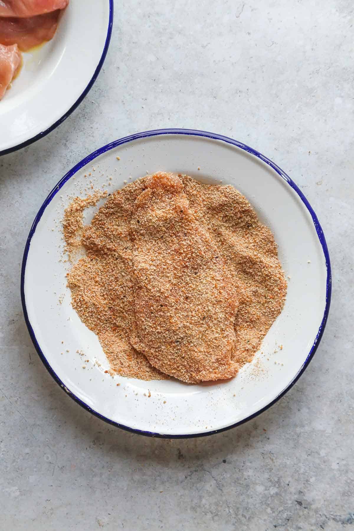 breaded chicken breast in breadcrumbs in a plate